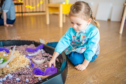 Child playing with sensory items