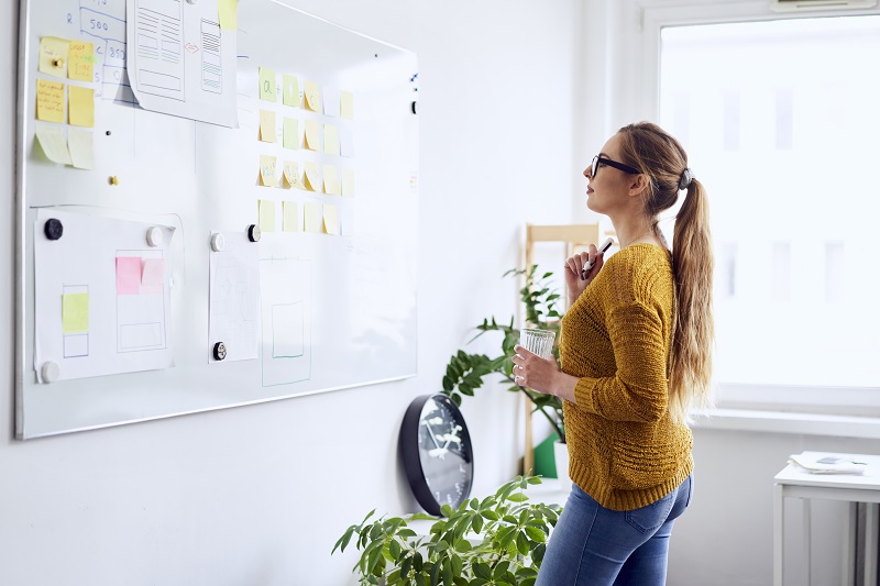 Educator reading documentation posted on a white board