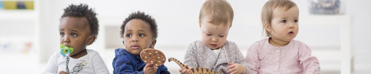 Infants sitting in a row