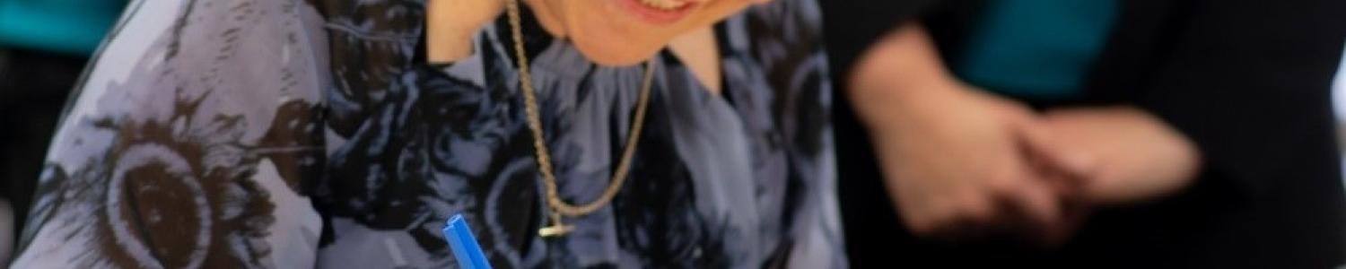 Julie Price Executive Director, Community Child Care Association, signing documents