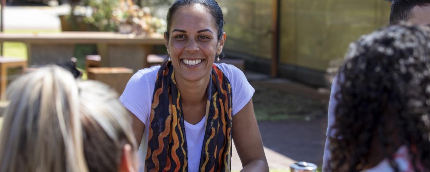Group of educators sitting at a table in a circle and in friendly discussion