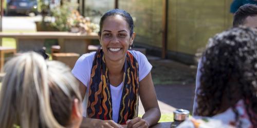 Group of educators sitting at a table in a circle and in friendly discussion