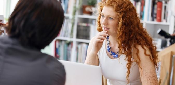 Educators at a desk in conversation