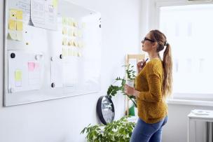 Educator reading documentation posted on a white board